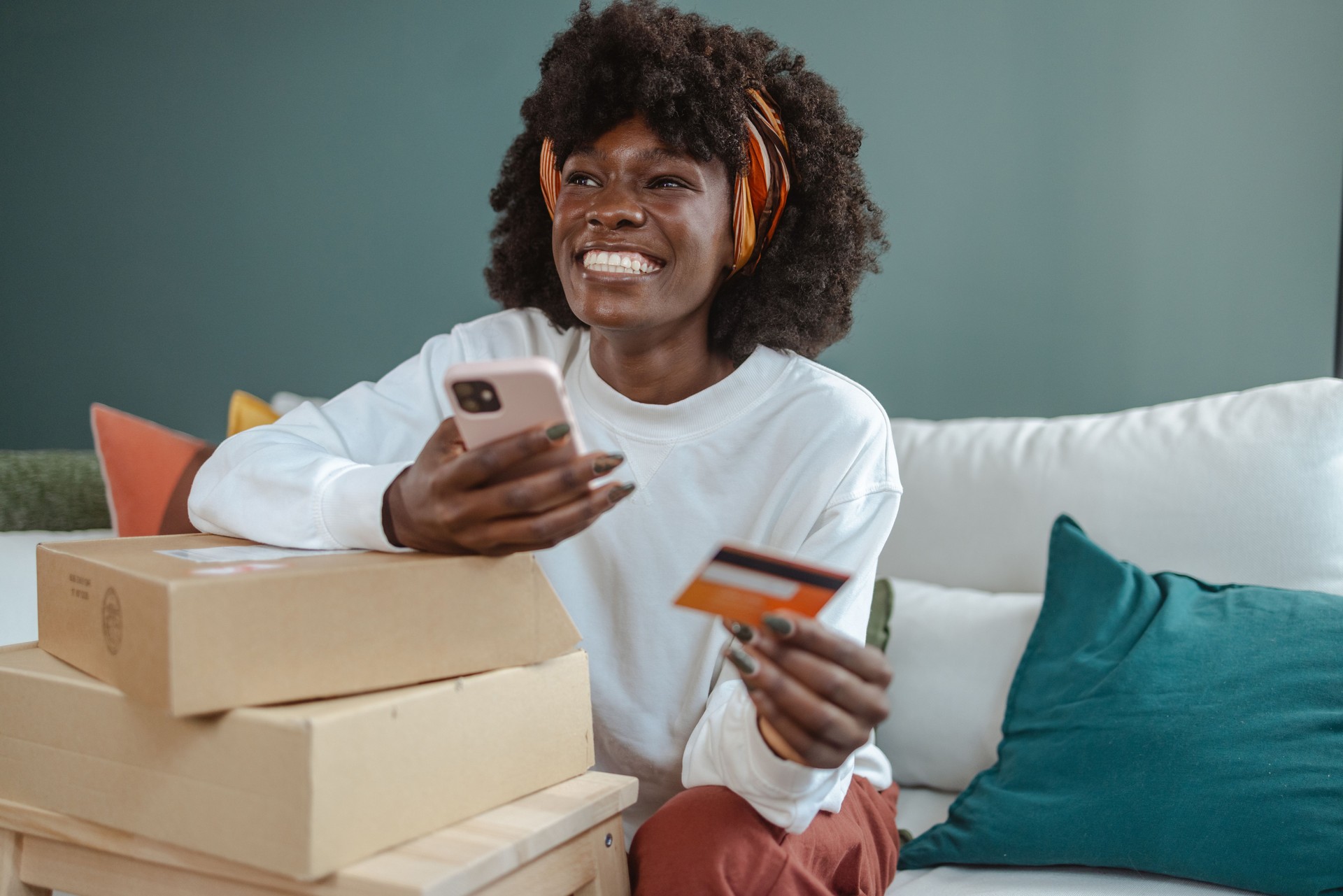 Young African American woman using online services for e-commerce activity at home